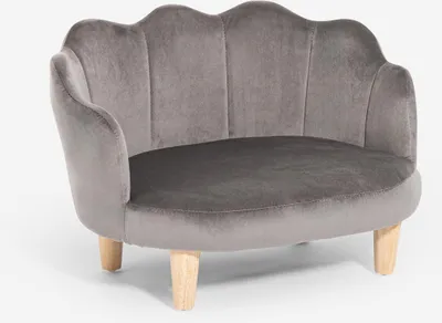 A gray velvet armchair with a shell-shaped back and wooden legs, presented on a white background.