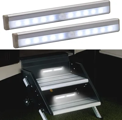 Two LED light strips are shown above a set of RV steps that are illuminated by similar lights.