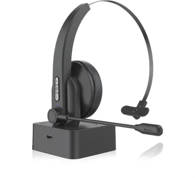 A black wireless headset with a microphone sits on its charging base against a white background.