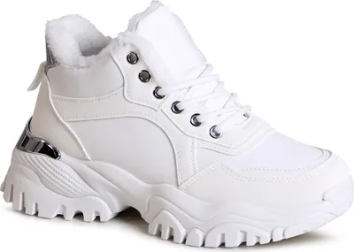 A studio shot of a single white sneaker.