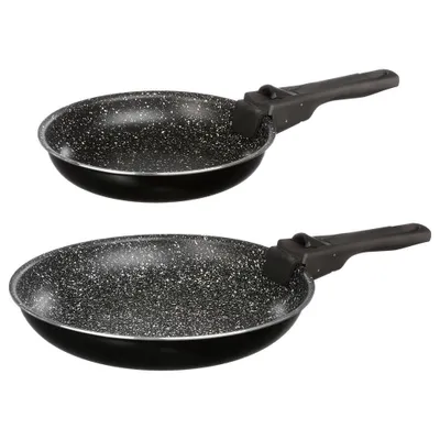 Two black frying pans with speckled interiors and black handles are shown against a white background.