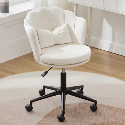 A white office chair with a shell-shaped back and a bow-shaped lumbar pillow sits on a rug.