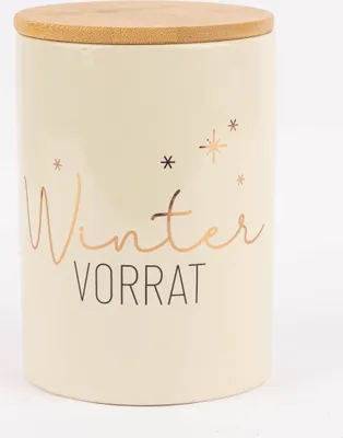 A cream-colored ceramic jar with a wooden lid, decorated with gold stars and the words "Winter Vorrat".