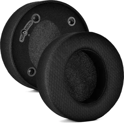 Two black headphone ear pads are shown, one slightly behind the other, on a white background. The ear pads have a textured outer surface and a soft inner surface.