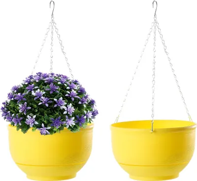 Two yellow hanging planters, one with purple flowers and greenery, the other empty, against a white background.