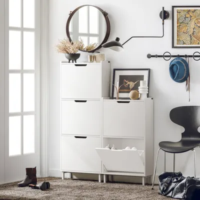 A hallway or entryway with a shoe cabinet, chair, and accessories.