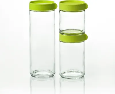 Two glass canisters with green lids are shown against a white background. One canister is stacked with a smaller canister on top, both with green lids.