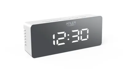 A white digital alarm clock with a mirrored LED display showing the time 12:30.