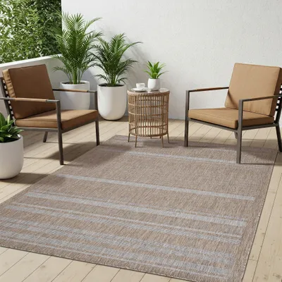 An outdoor patio scene with furniture and plants.