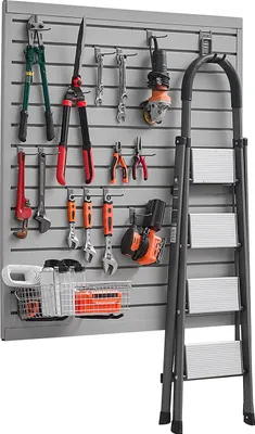 A wall-mounted tool organizer with various tools and a ladder.