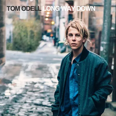A young man stands in an alleyway, looking towards the camera. The album title and artist name are displayed at the top of the image.
