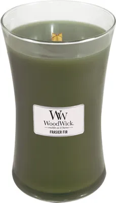 A green WoodWick candle in a clear glass jar with a wooden wick.