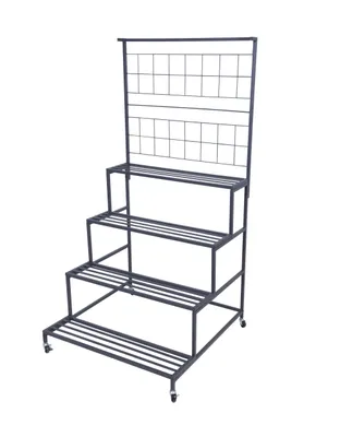 A multi-tiered metal plant stand with a trellis back.