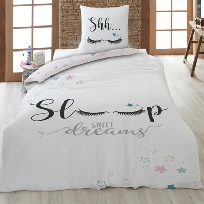 A bedding set is displayed on a bed in a bedroom setting.