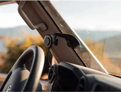 Interior view of a vehicle showing a car mount attached to the windshield.