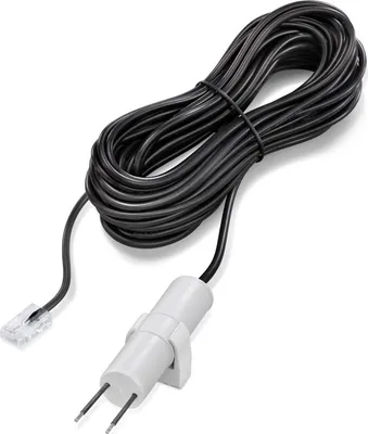 A black cable with a white adapter and two metal prongs is coiled on a white background.