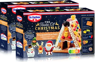 Two boxes of Dr. Oetker 'The Taste of Christmas' gingerbread house kit, with decorations.