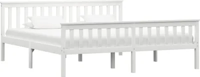 A white wooden bed frame with a mattress and pillow.