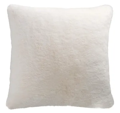 A white faux fur pillow cover on a white background.