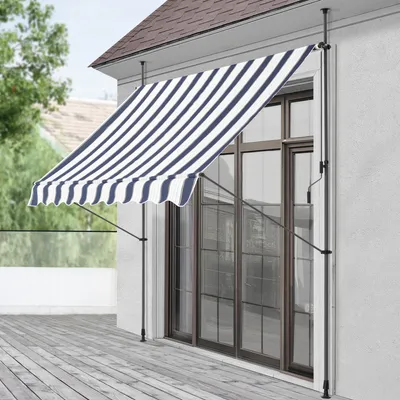 An awning is extended over a sliding glass door on a house.