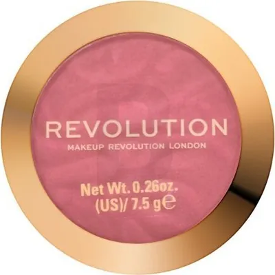 A top-down view of a round makeup compact with a gold rim and pink powder inside.