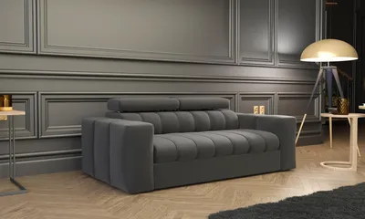 A modern living room scene with a gray sofa, a floor lamp, and side tables.