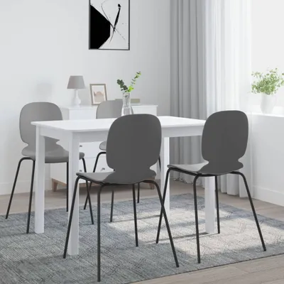 A dining table with four chairs in a room with a white dresser and abstract art on the wall.