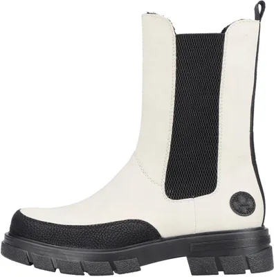 A side view of a beige and black Chelsea boot.
