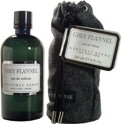 A bottle of Geoffrey Beene Grey Flannel Eau de Toilette and its accompanying drawstring pouch are displayed against a light gray background.