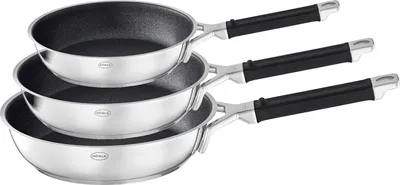 A set of three stainless steel frying pans with black handles, stacked on a white background.