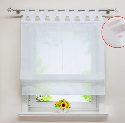A white Roman blind with tab loops hangs on a window, with a small bouquet of sunflowers on the windowsill below.
