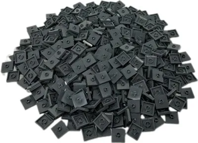 A pile of small, dark gray, square LEGO® tiles with a circular indentation in the center.