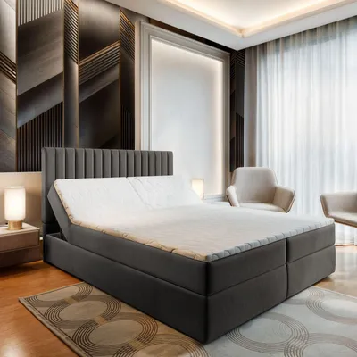 A modern bedroom with a large boxspring bed as the main focus.