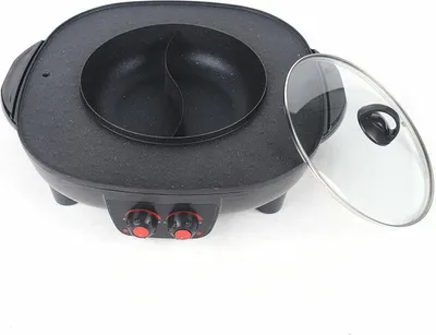 A black electric grill and hot pot with a clear glass lid is shown on a white background.