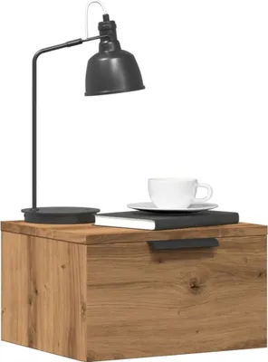 A bedside table with a lamp and a cup of coffee.