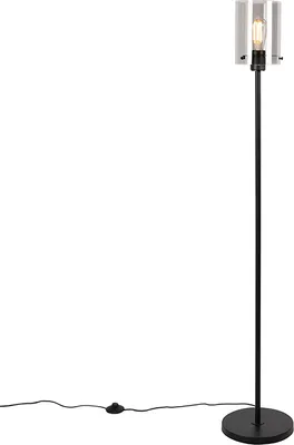 A black floor lamp with a clear glass shade and a visible light bulb, standing on a white background.