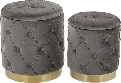 Two grey tufted storage ottomans with gold bases are shown side-by-side against a white background.