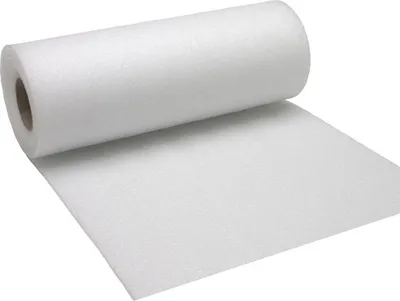 A roll of white foam material is shown, with a portion unrolled onto a flat surface.
