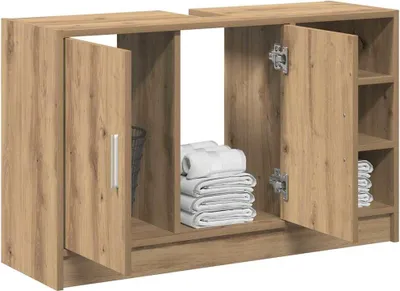 A wooden bathroom cabinet with open doors, showing folded towels inside.