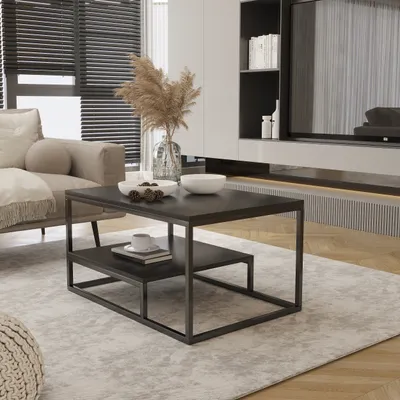 A modern living room scene featuring a coffee table with decorative items, a sofa, and a media console.
