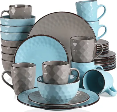 A collection of blue and gray ceramic dishes and mugs are neatly arranged.