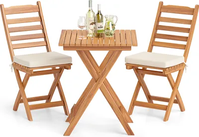 A wooden bistro set with two chairs and a table, set up for a drink.