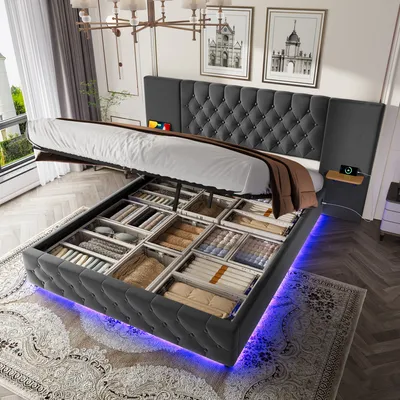 A bed with its storage compartments open, showcasing organized items and illuminated by LED lights.
