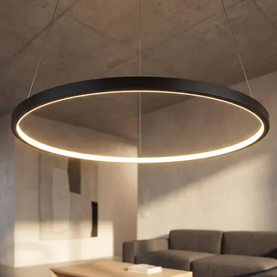 A modern living room with a concrete ceiling, a large abstract painting on the wall, a sofa, and a coffee table. A circular pendant light hangs from the ceiling.