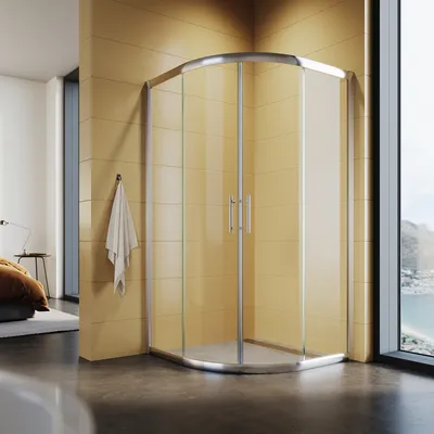 A modern bathroom with a corner shower enclosure.
