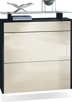 Produktbild von Vladon Schuhschrank Annie, Schuhkipper für 16 Paar Schuhe mit 2 Klappen, 1 Schublade und Glasablage, Schwarz matt/Creme Hochglanz, Griffmulden in Creme Hochglanz (89 x 95,5 x 23 cm)