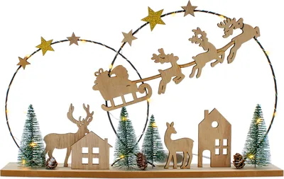 A wooden Christmas village scene with Santa's sleigh and reindeer.