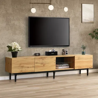 A modern living room with a TV stand and a large television.