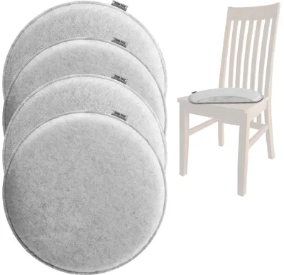 A stack of four round gray felt seat cushions and one seat cushion on a chair.