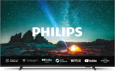 A Philips television displaying a scenic night sky with mountains and a tent.